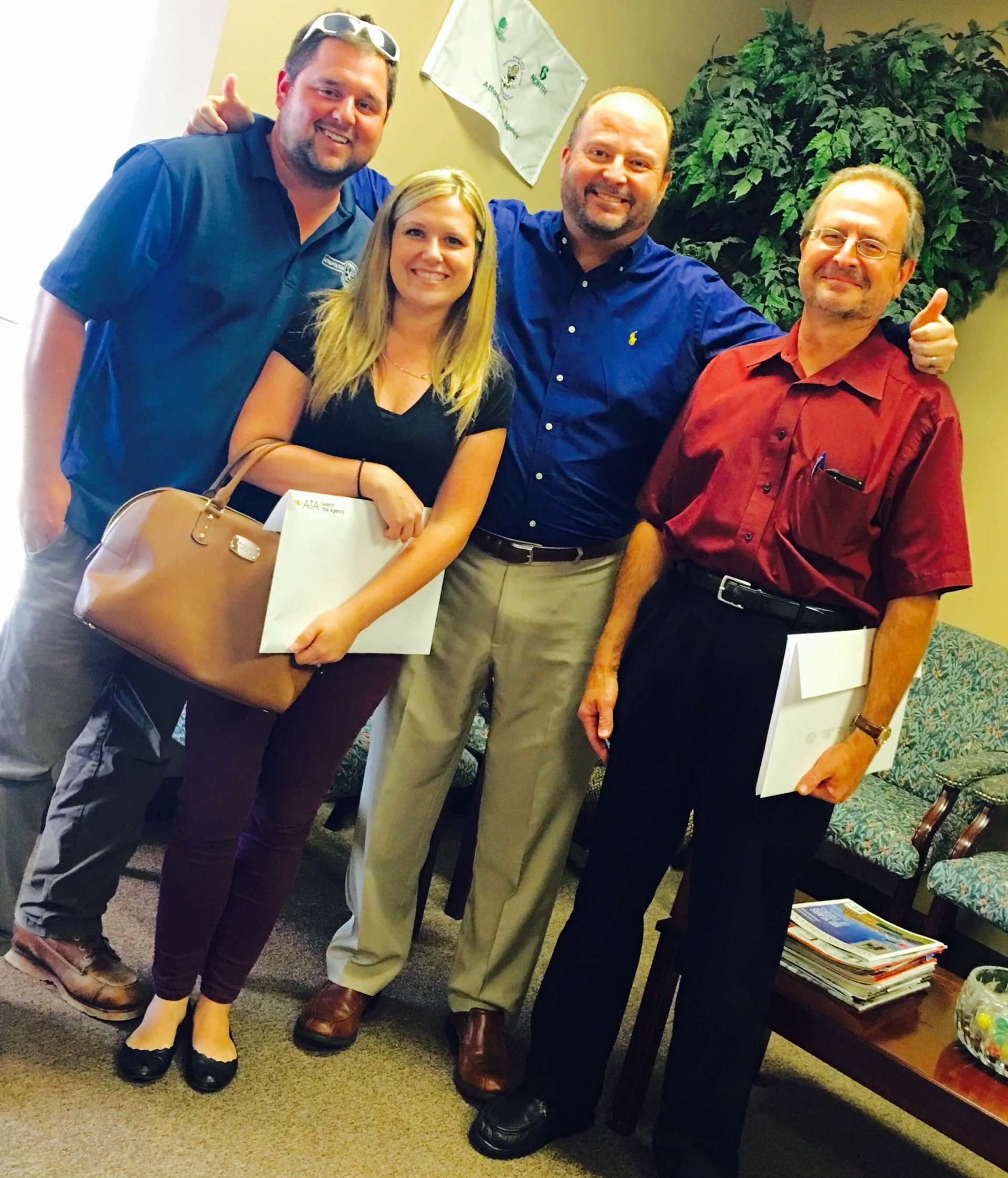 A group of people posing for a picture in a waiting room.