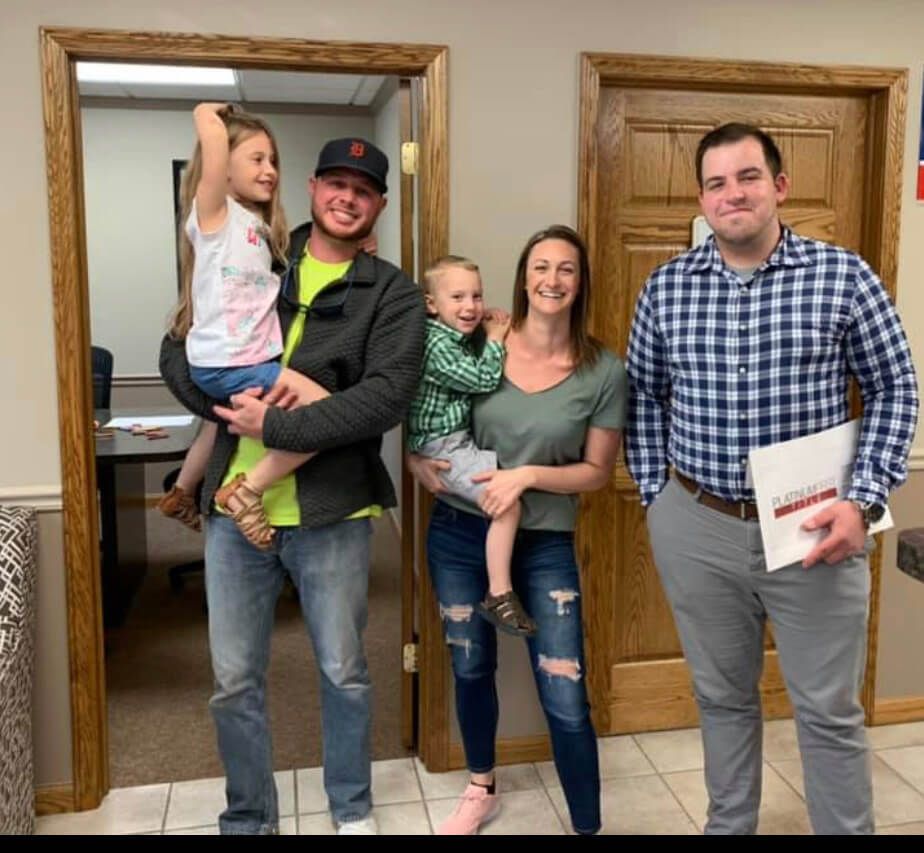 A group of people posing for a picture in a hallway.