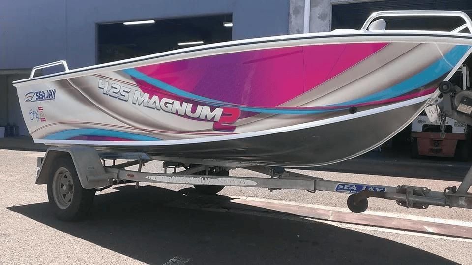 A Boat with The Word Magnum on It Is on A Trailer — Signmax Bundaberg In Kensington, QLD