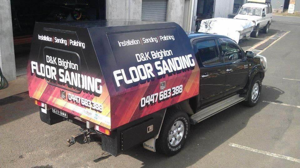 A Black Truck with A Canopy on The Back Is Parked on The Side of The Road — Signmax Bundaberg In Kensington, QLD