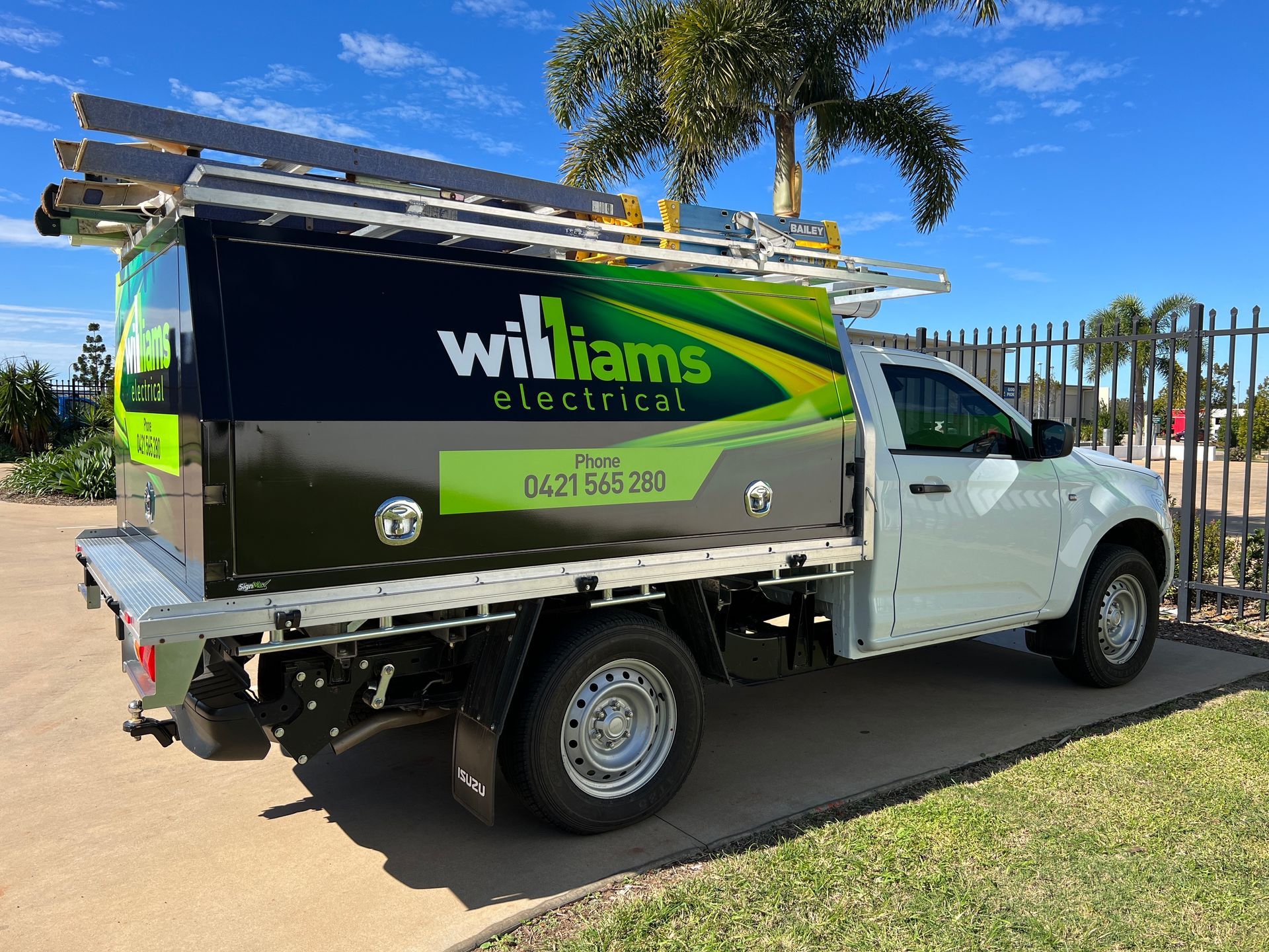 Three Workers Install a Large Blue Sign Outdoors — Signmax Bundaberg In Kensington, QLD