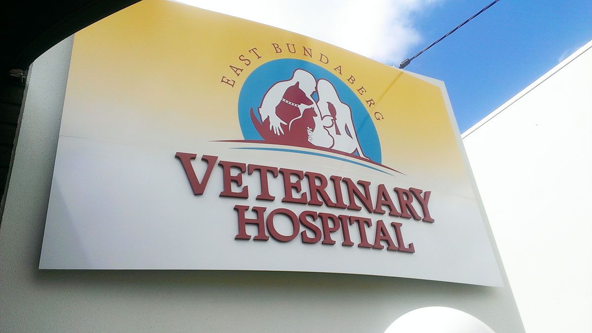 A Sign With Stylized Animal Silhouettes and Bold Red Text — Signmax Bundaberg In Kensington, QLD