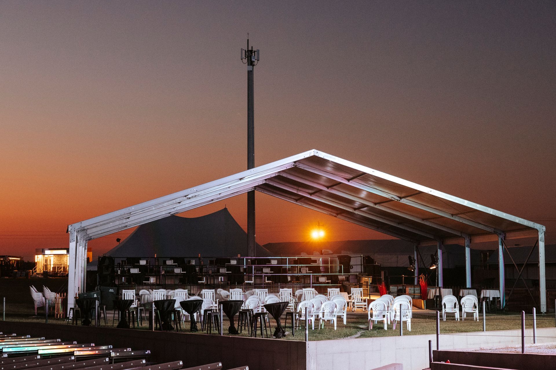Festival venue at sunset with empty chairs
