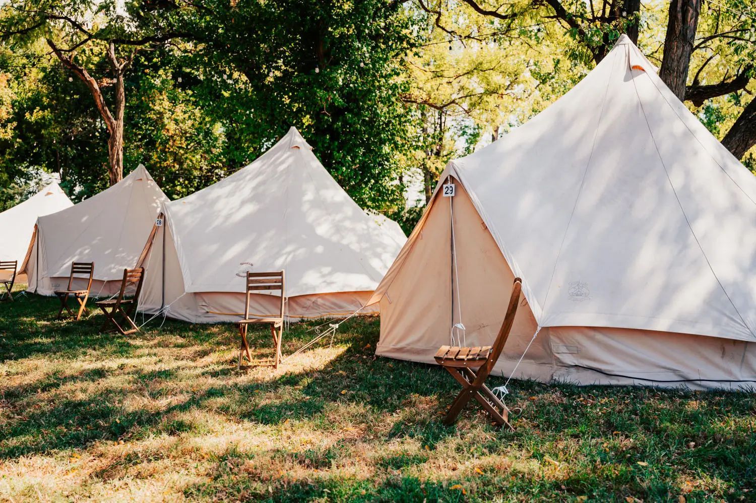 Glamping bell tents with wooden chairs