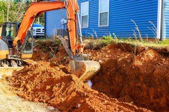 Excavator digging soil in backyard