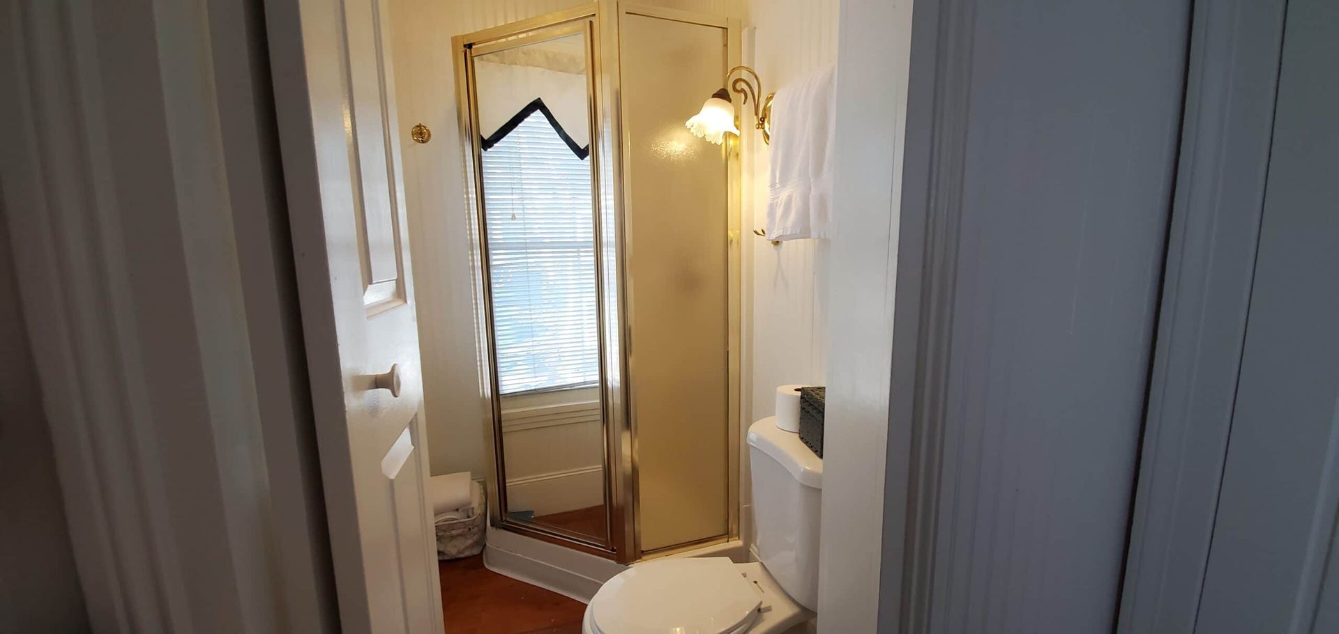 A bathroom with a toilet and a shower stall.