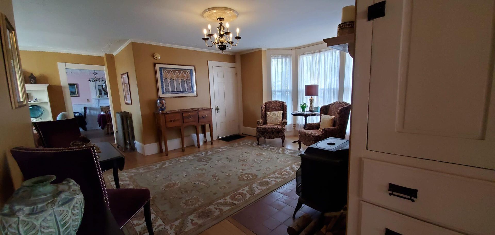 A living room filled with furniture and a wood stove.