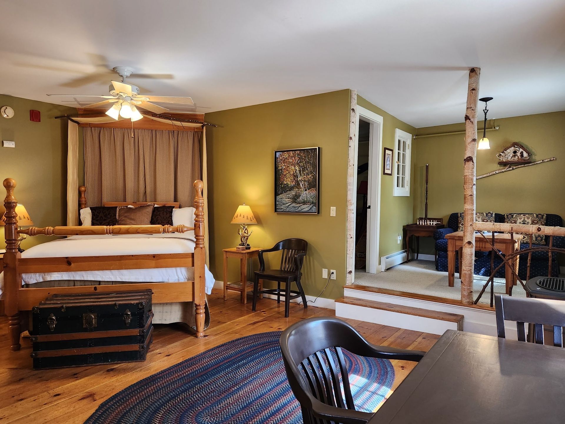 A bedroom with a four poster bed and a ceiling fan.