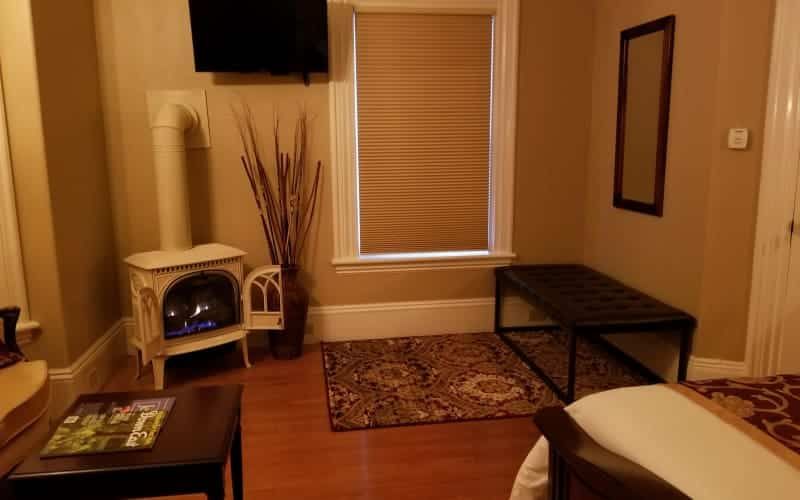 A living room with a fireplace and a flat screen tv.