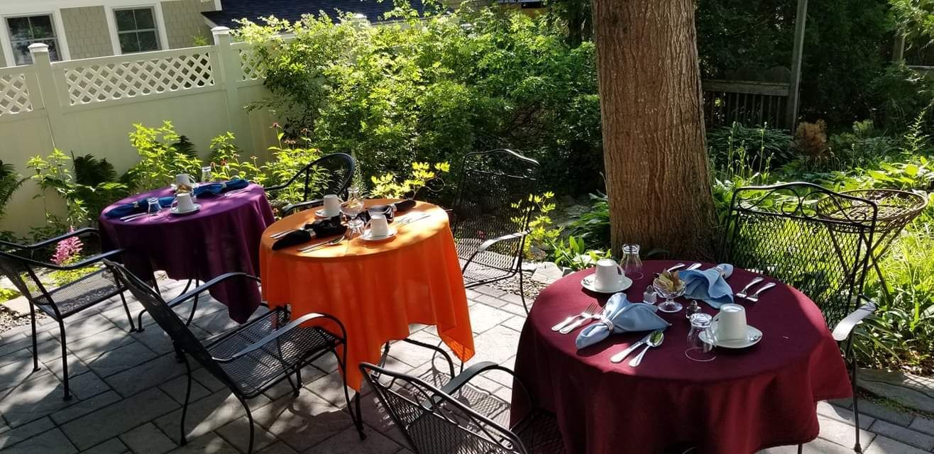 A patio with tables and chairs set up for a party.