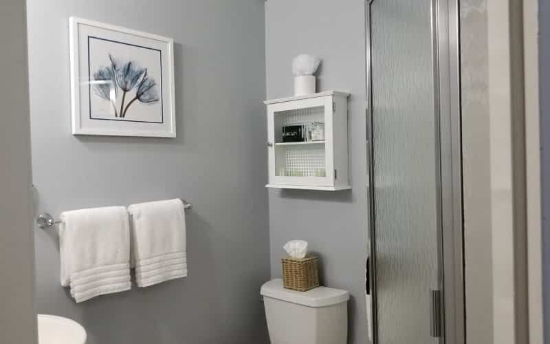 A bathroom with a toilet , sink , and shower.