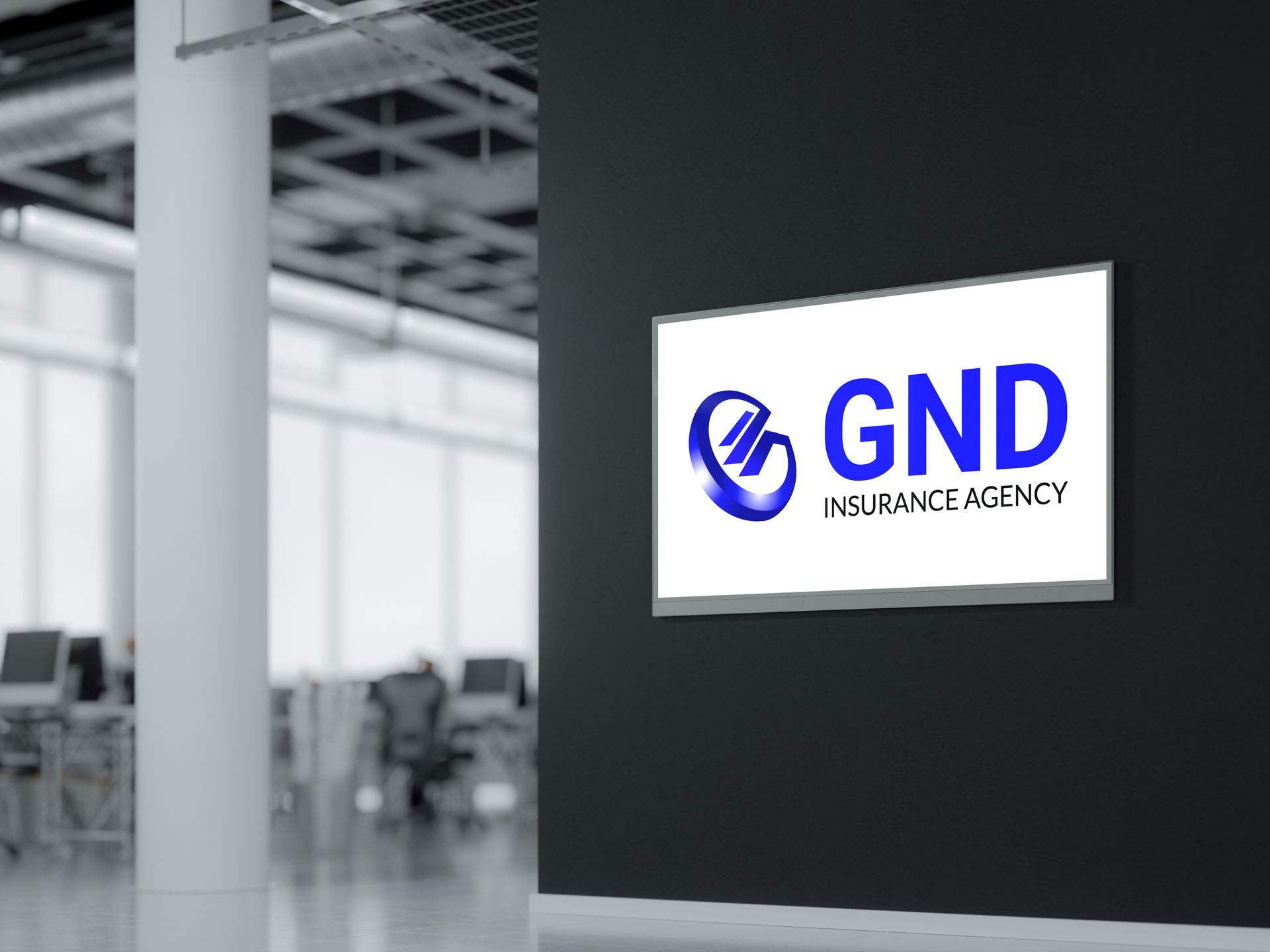 GND Insurance Agency sign on black wall in office. Logo is blue and white with the letters GND.