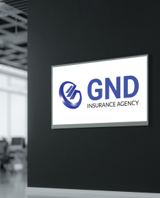 GND Insurance Agency sign on black wall in an office. White and blue logo.