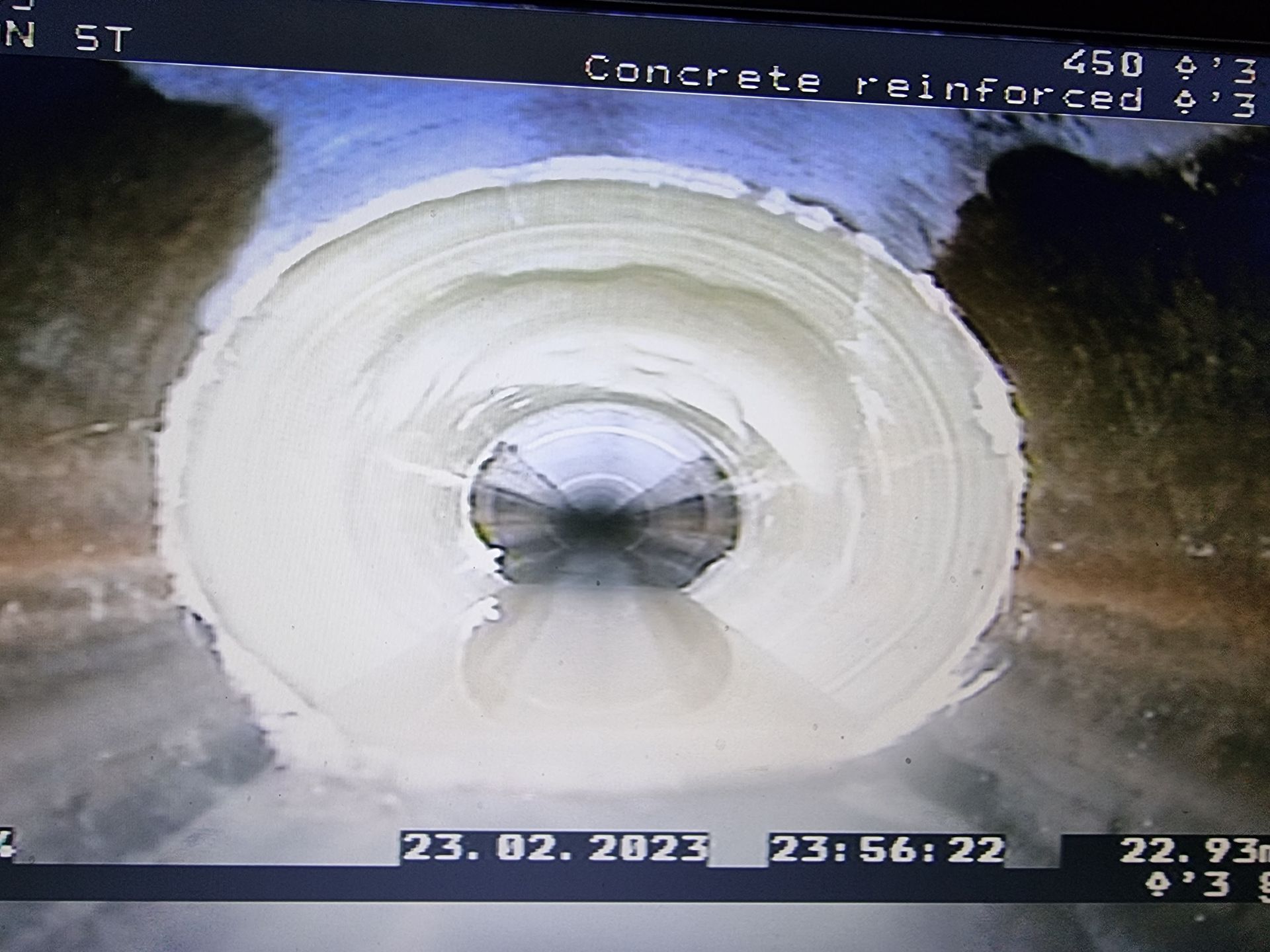 View inside a concrete reinforced tunnel, with circular shape. The tunnel has white lining — Pro Pipe Solutions in Queanbeyan, NSW