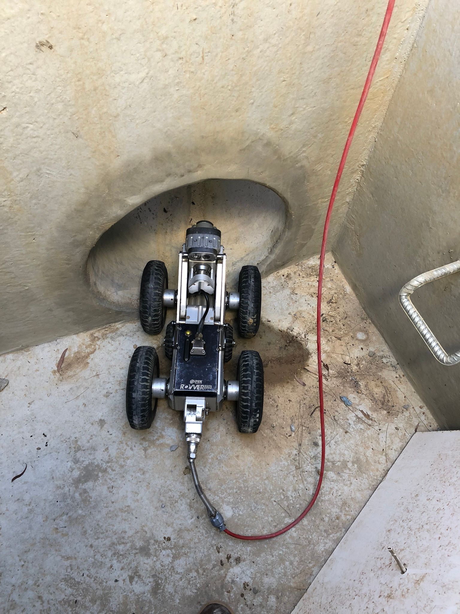 Robotic camera inside a concrete pipe. Red cable extends upward — Pro Pipe Solutions in Goulburn, NSW