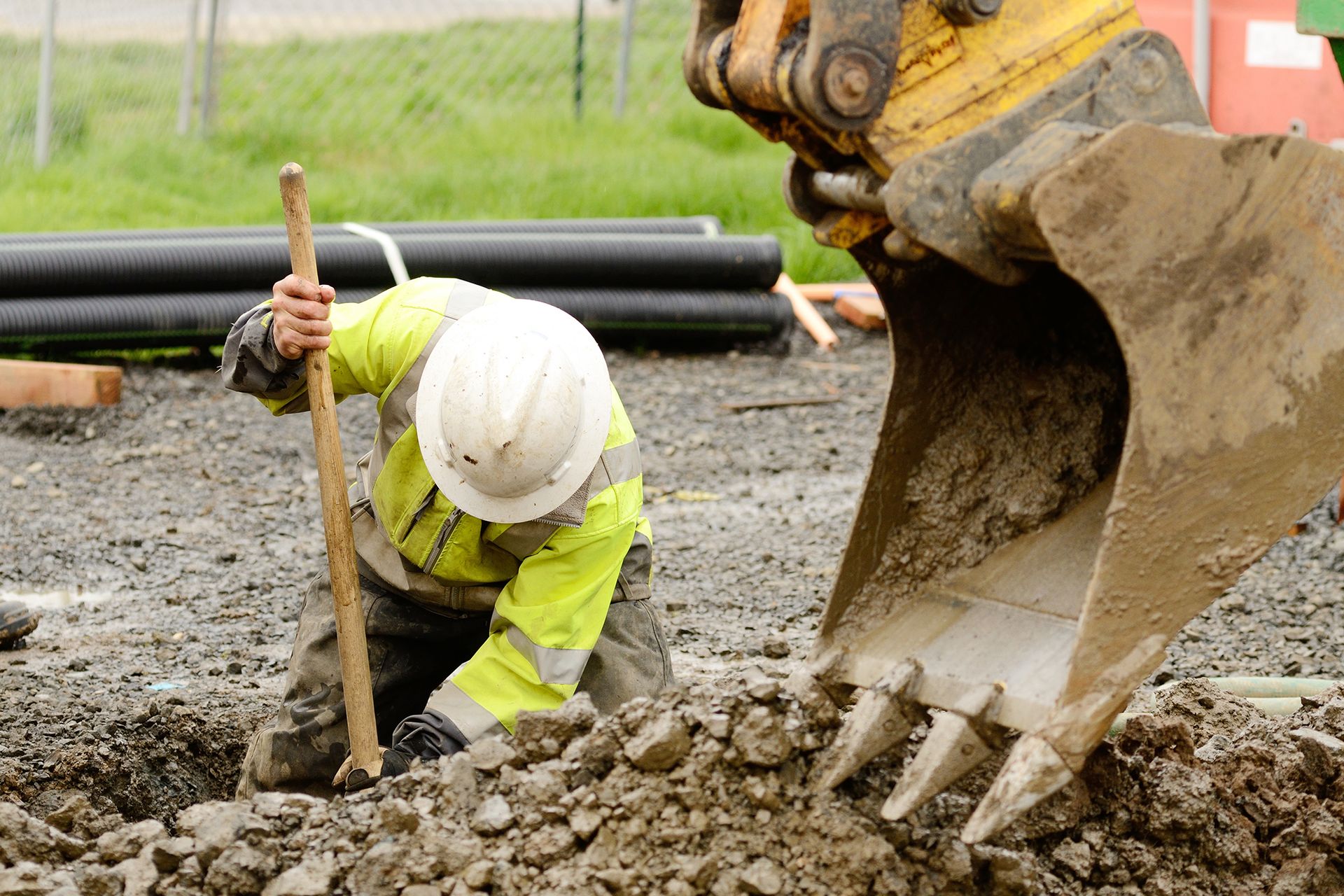 Worker Digging in the Dirt With Shovel