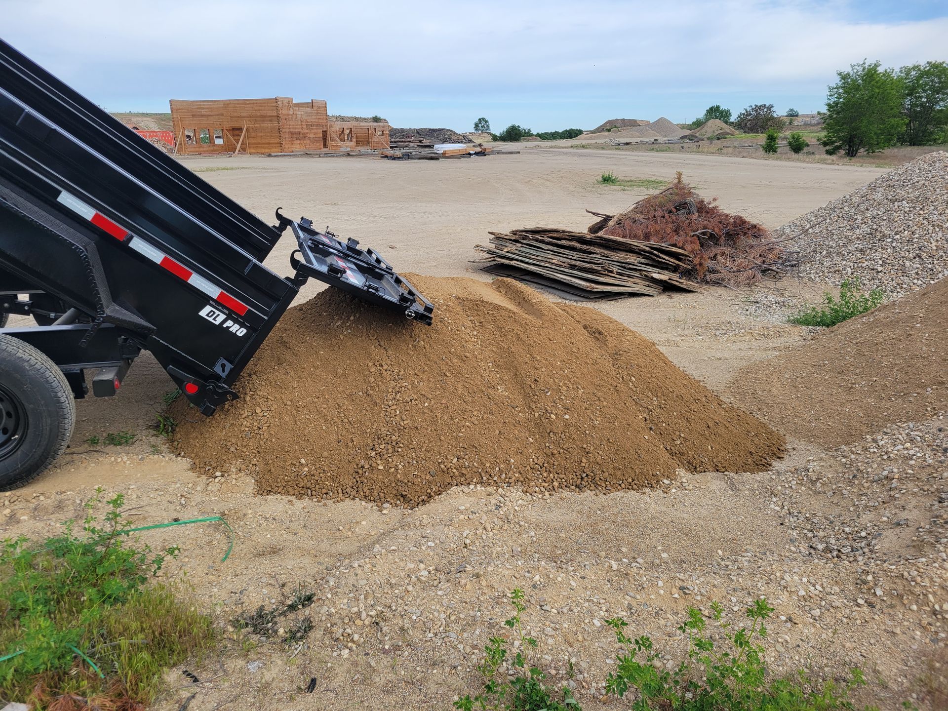 Dump Truck Dumping Dirt Into a Pile