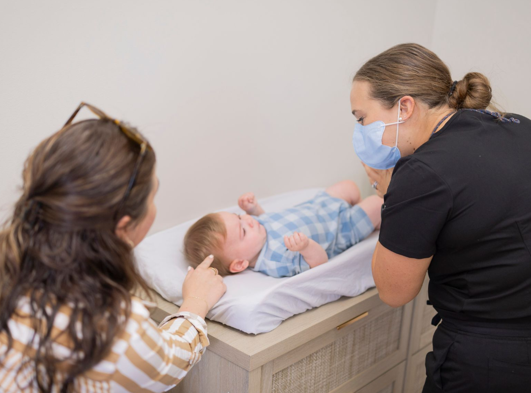 Dr. Deacy performing an infant frenectomy consultation at Signature Smiles KC