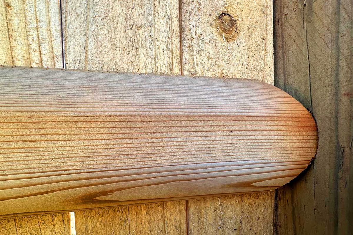 A close up of a piece of wood on a wooden surface.