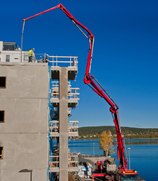 A man is sitting at a desk working on electronics