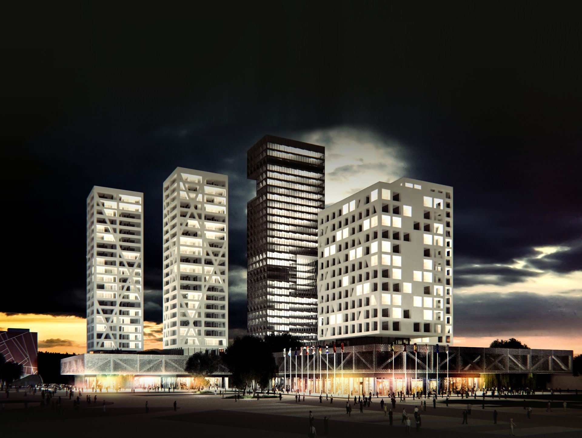 Un grupo de edificios altos se iluminan por la noche.