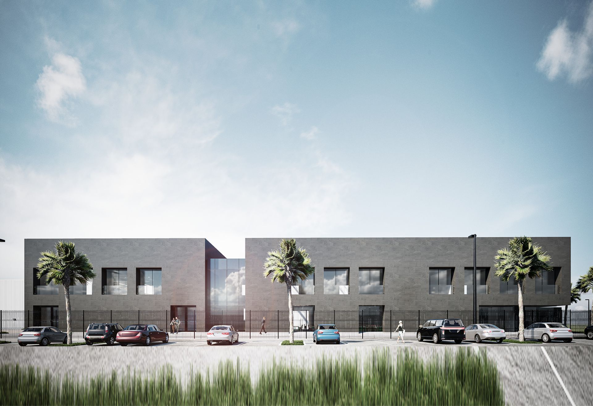 Edificio moderno de color gris con coches aparcados en el frente, bajo un cielo azul con algunos árboles.