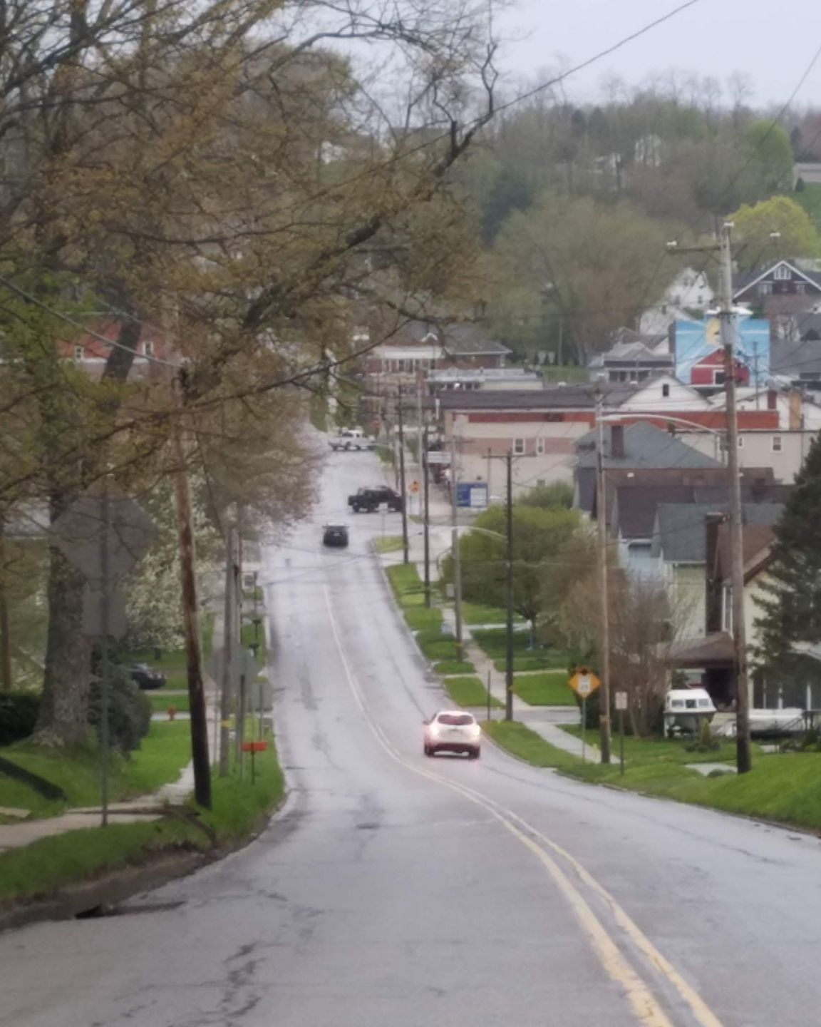 Person holding scales of justice, gavel on table, legal setting.
