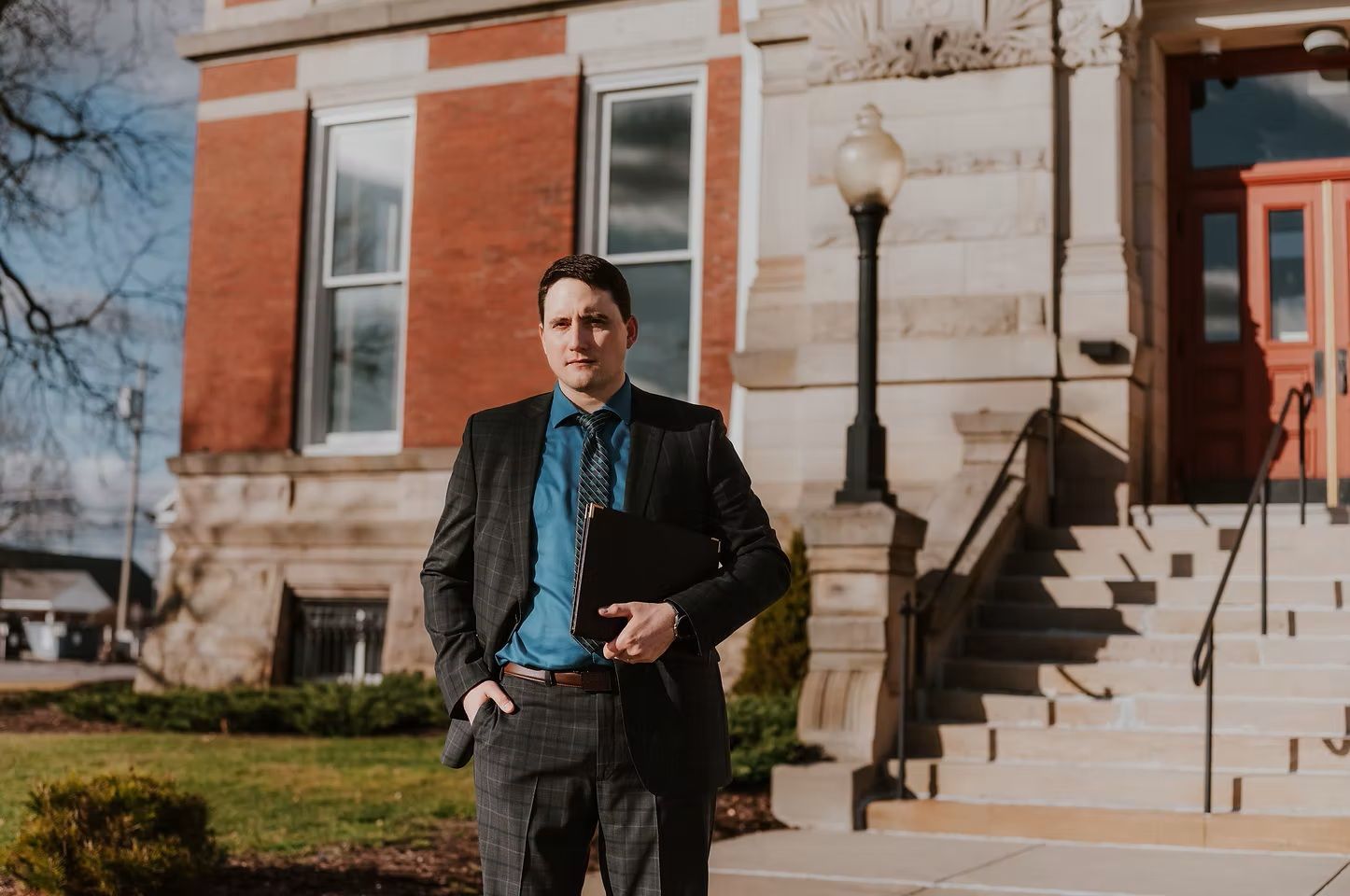 Group of people outside a law office; the sign reads