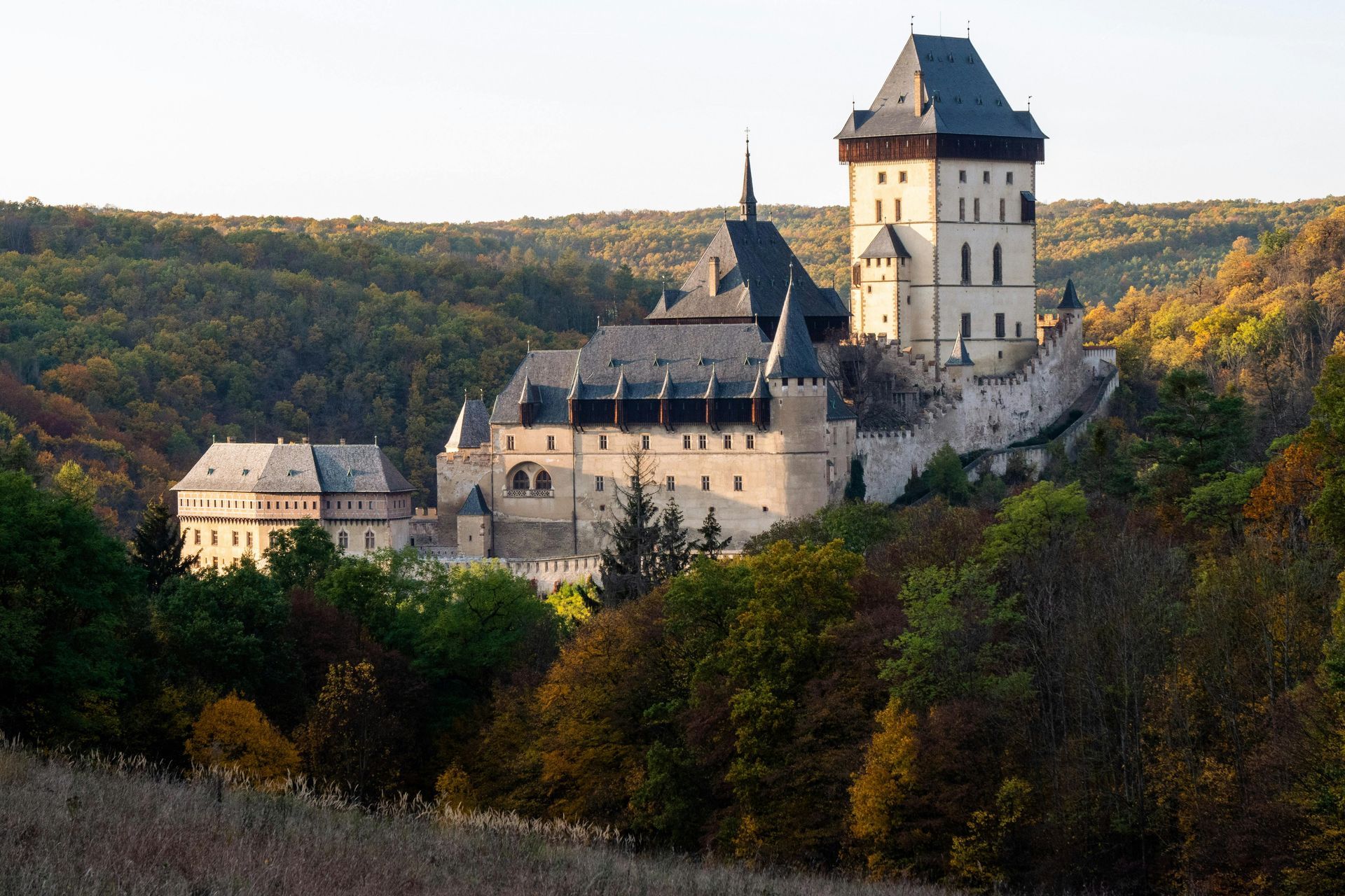 Karlstejn Castle on a hill surrounded by forest, iconic medieval fortress near Prague in the Czech R