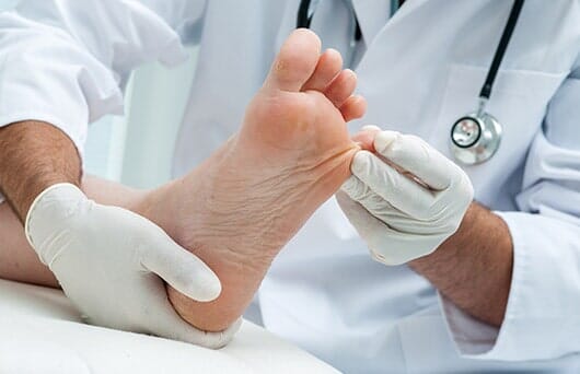 Doctor Checking Foot — Podiatry Clinic in Eugene, OR
