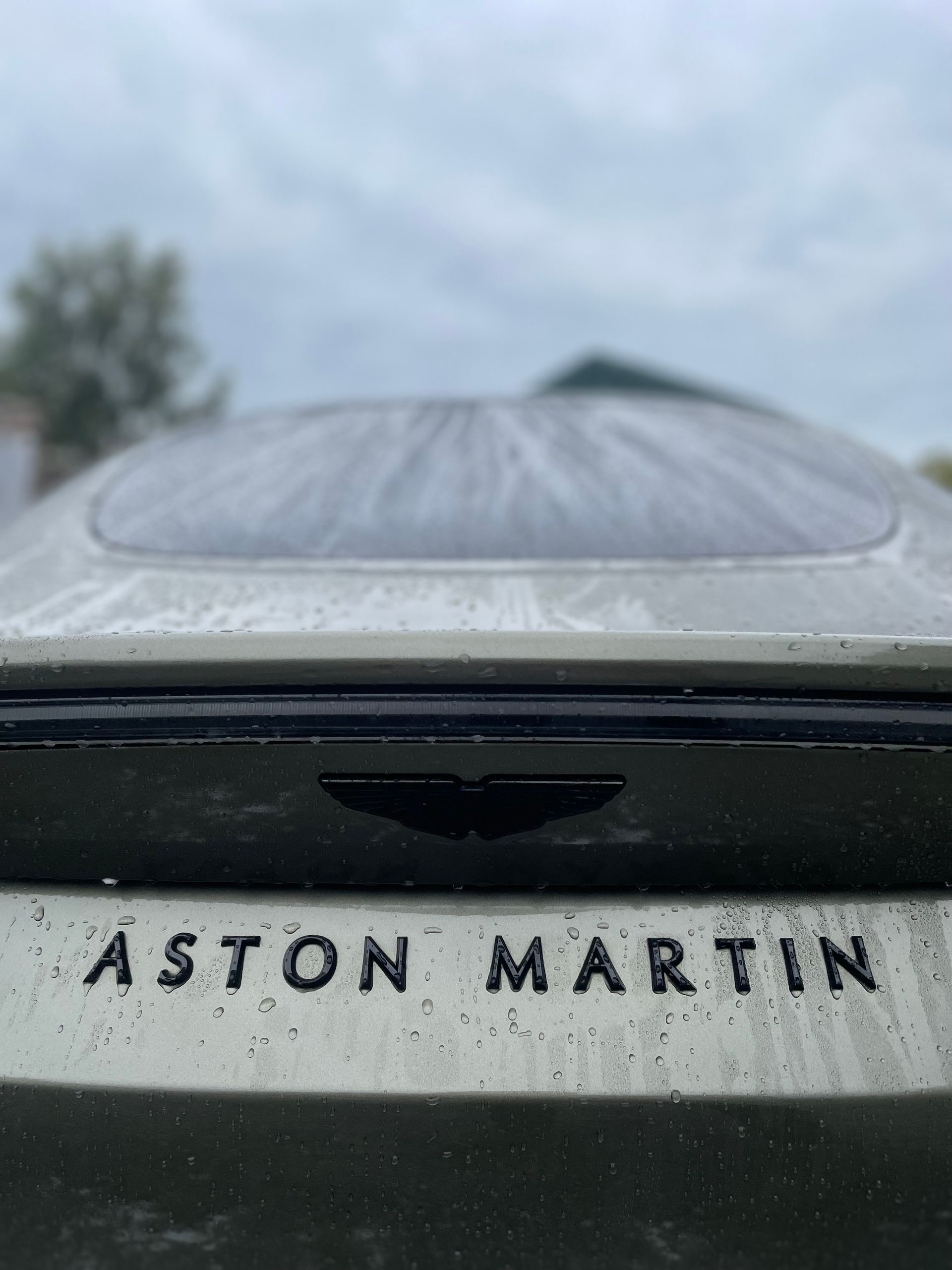 Rear view of an Aston Martin sports car, with the brand name and logo visible.