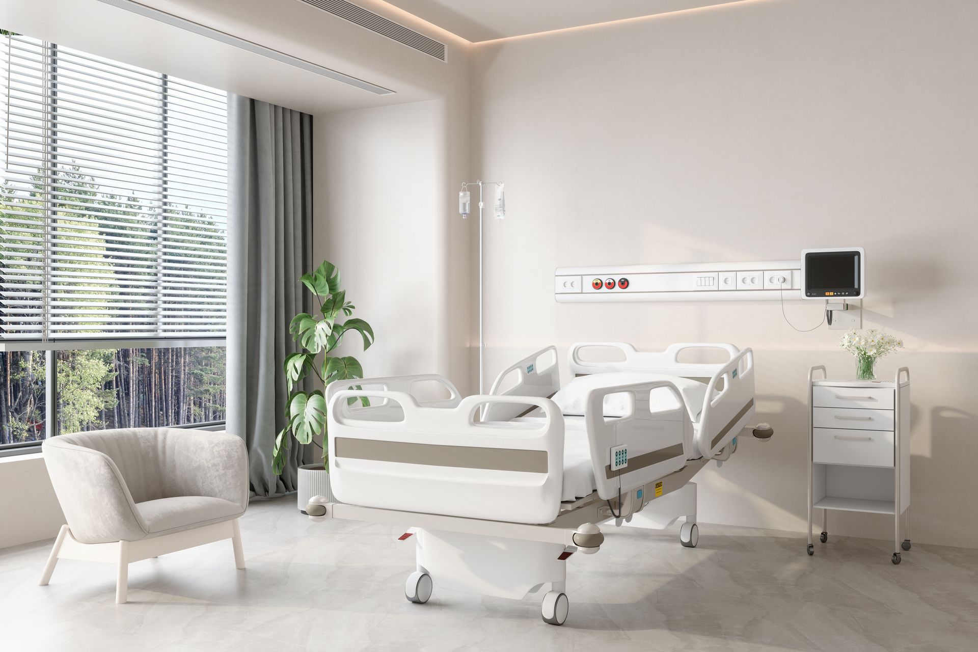 A modern hospital room with a white adjustable bed, an armchair by a window with blinds, and a medical bedside cabinet.