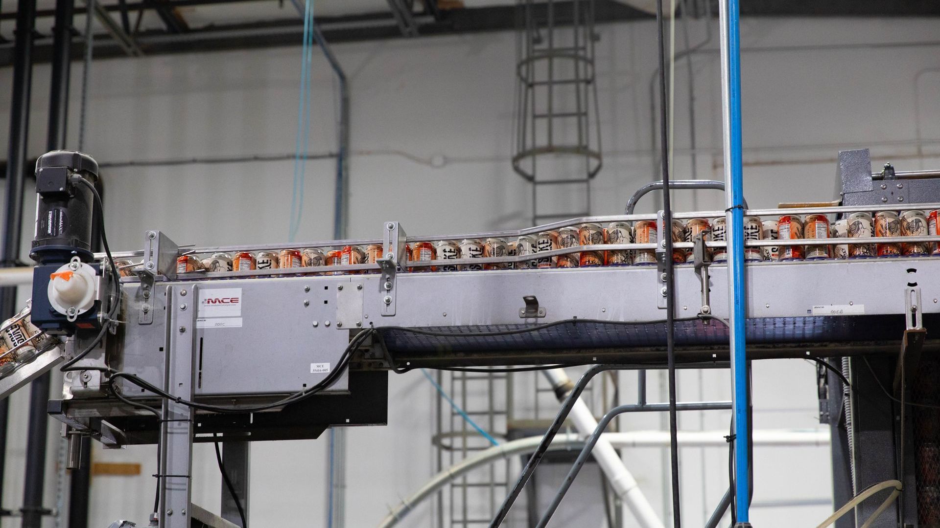 a conveyor belt filled with boxes of food in a factory .