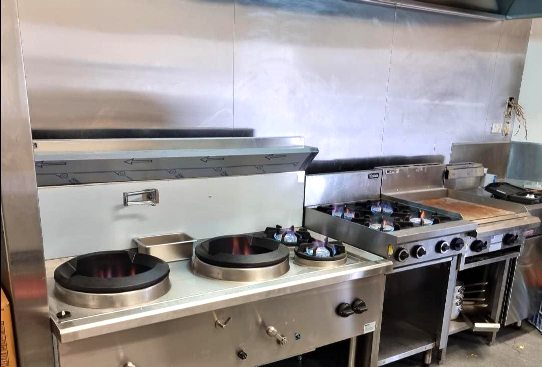 A Stainless Steel Commercial Kitchen Stove — D & B Plumbing NQ in Trinity Beach, QLD