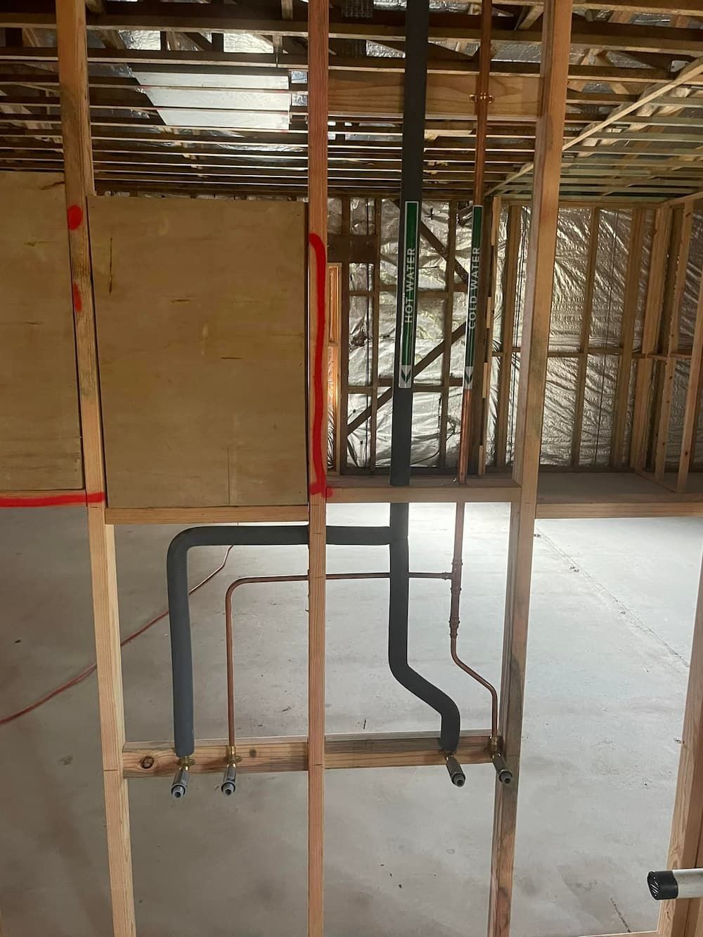 Interior View of a Wood-framed Wall Under Construction, Showing Plumbing Pipes — D & B Plumbing NQ in Smithfield, QLD