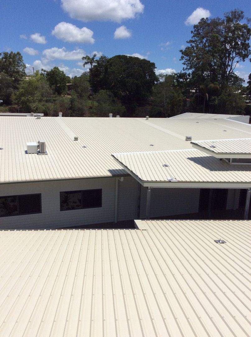 Construction Site: Workers Installing Concrete Pipes in a Deep Trench — D & B Plumbing NQ in Trinity Beach, QLD