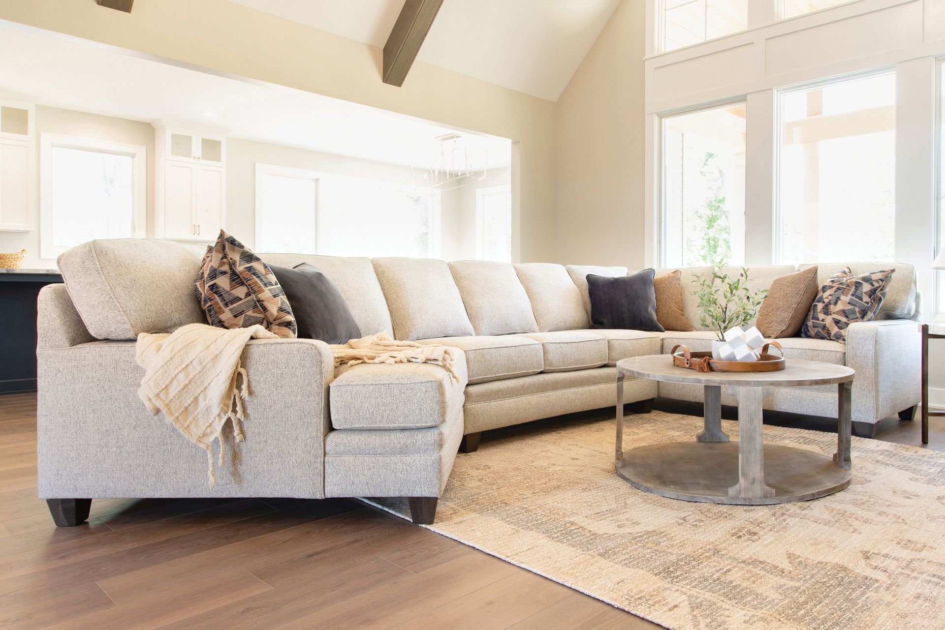 A living room with a large sectional couch and a coffee table.