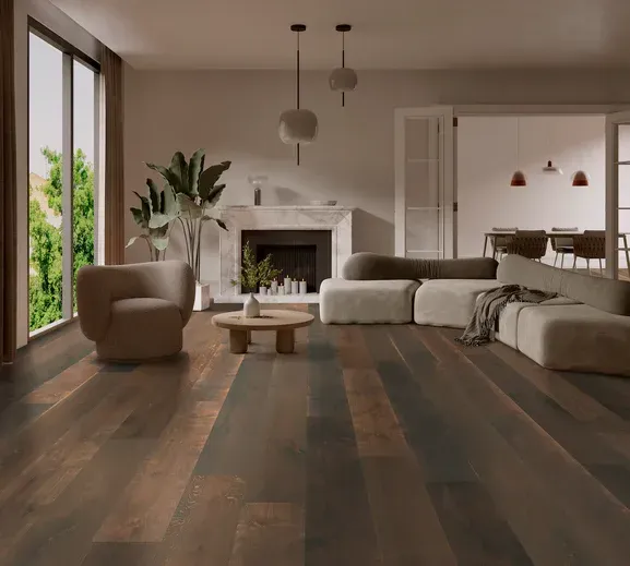 A living room with a couch , chair , coffee table and fireplace.