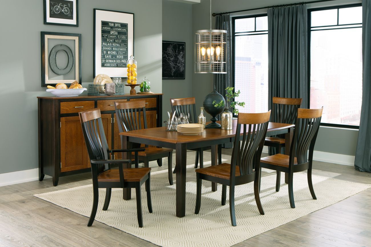 A dining room with a table and chairs and a buffet.