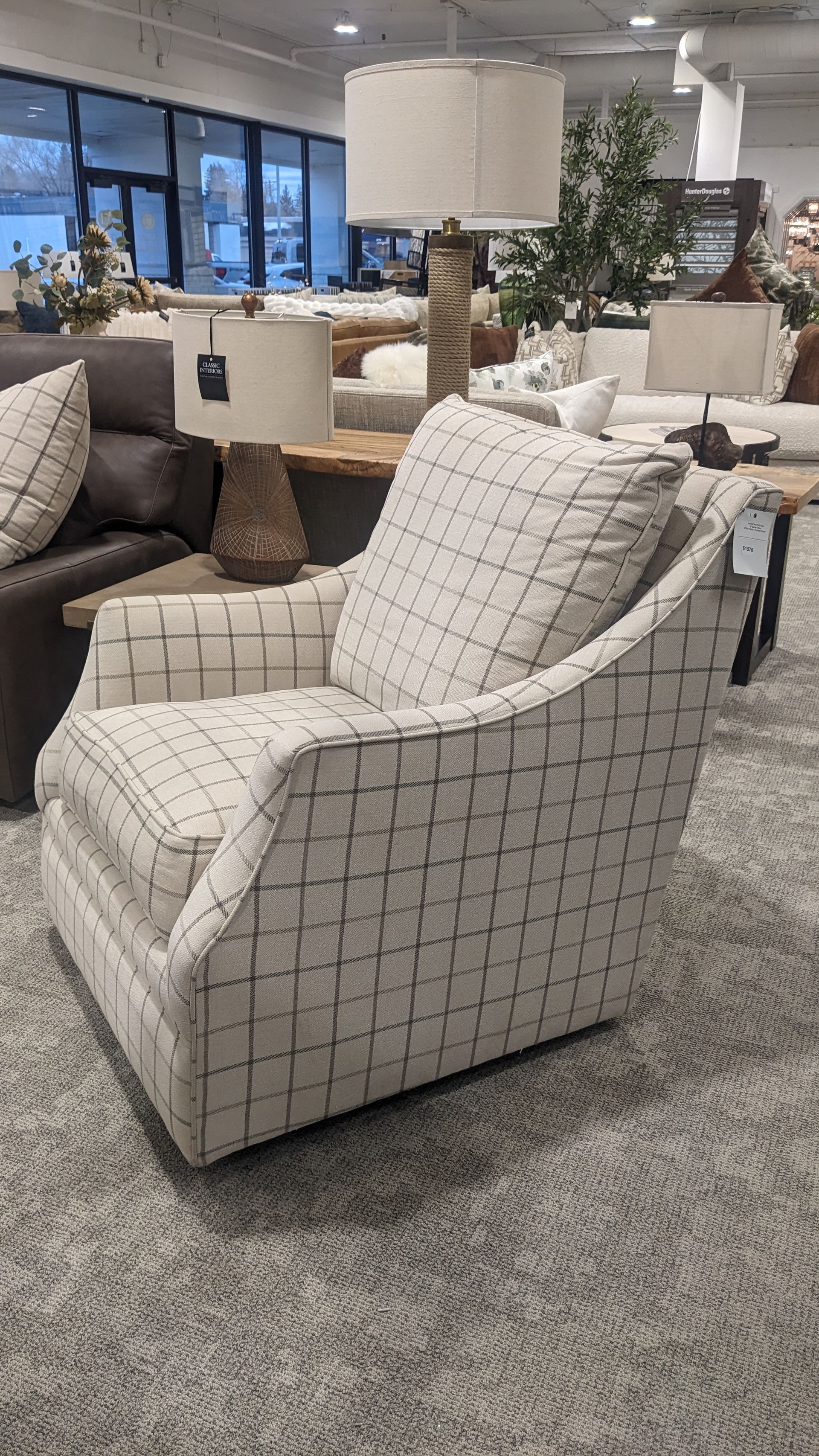 A chair is sitting in a living room in a furniture store.