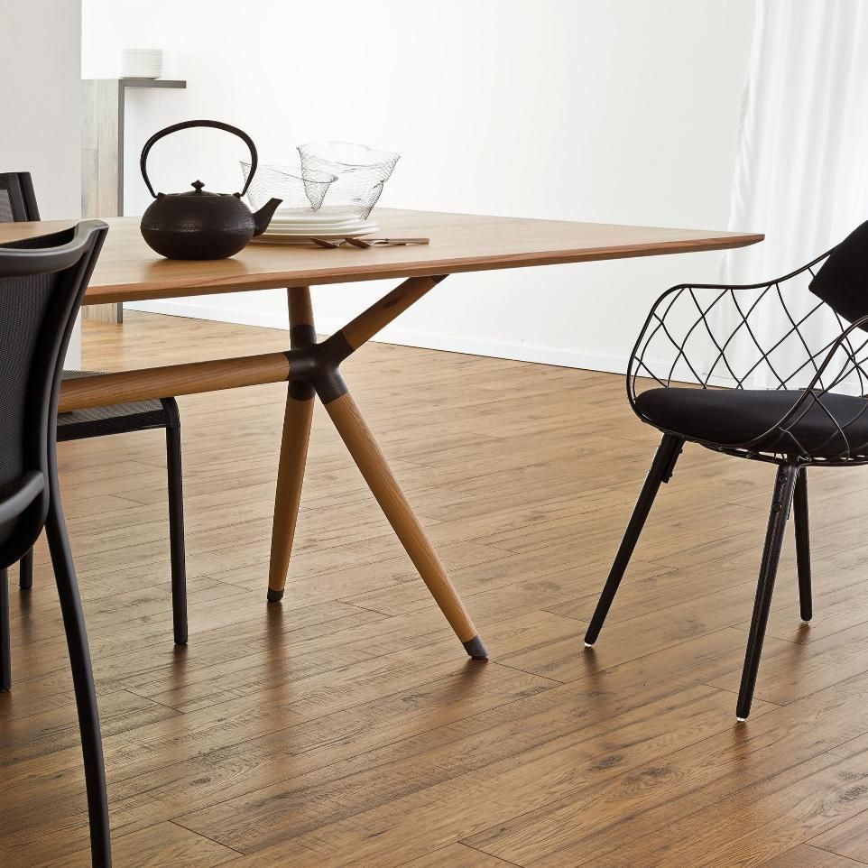 A wooden table with a black chair in front of it