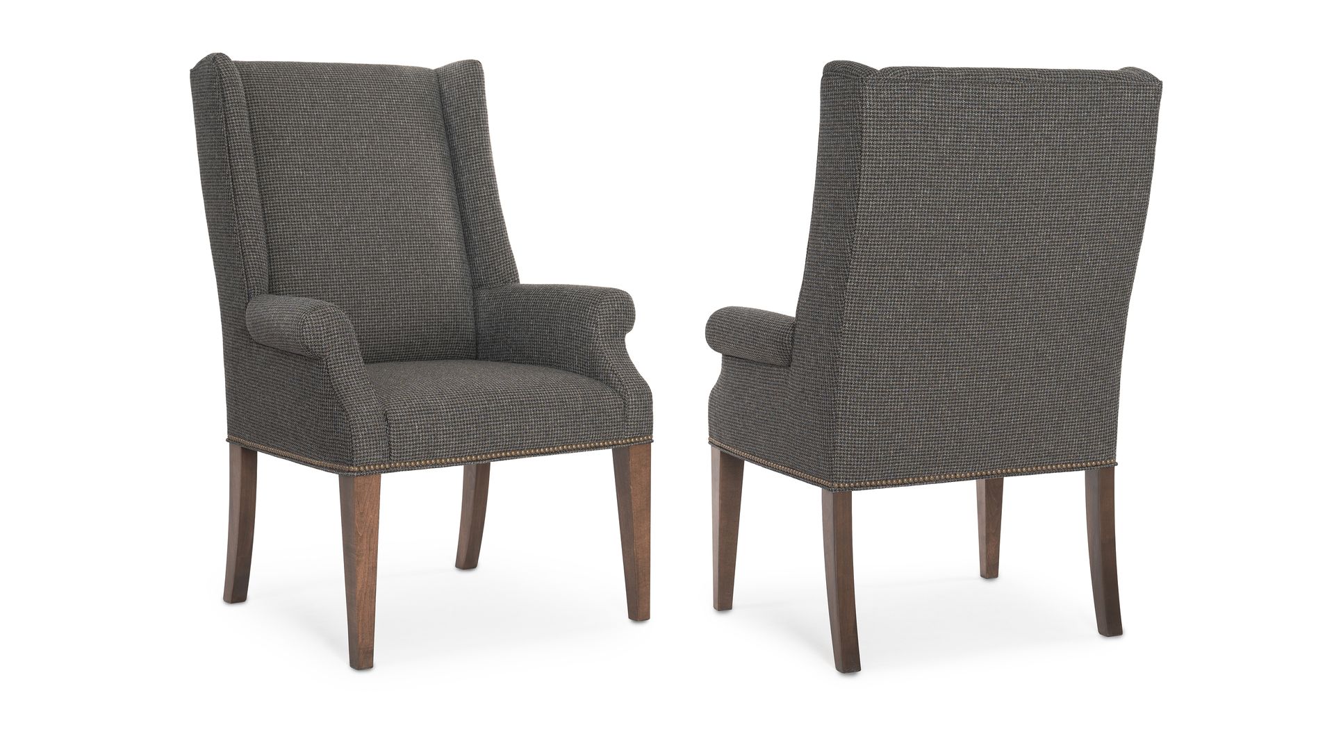 Two chairs are sitting next to each other on a white background.