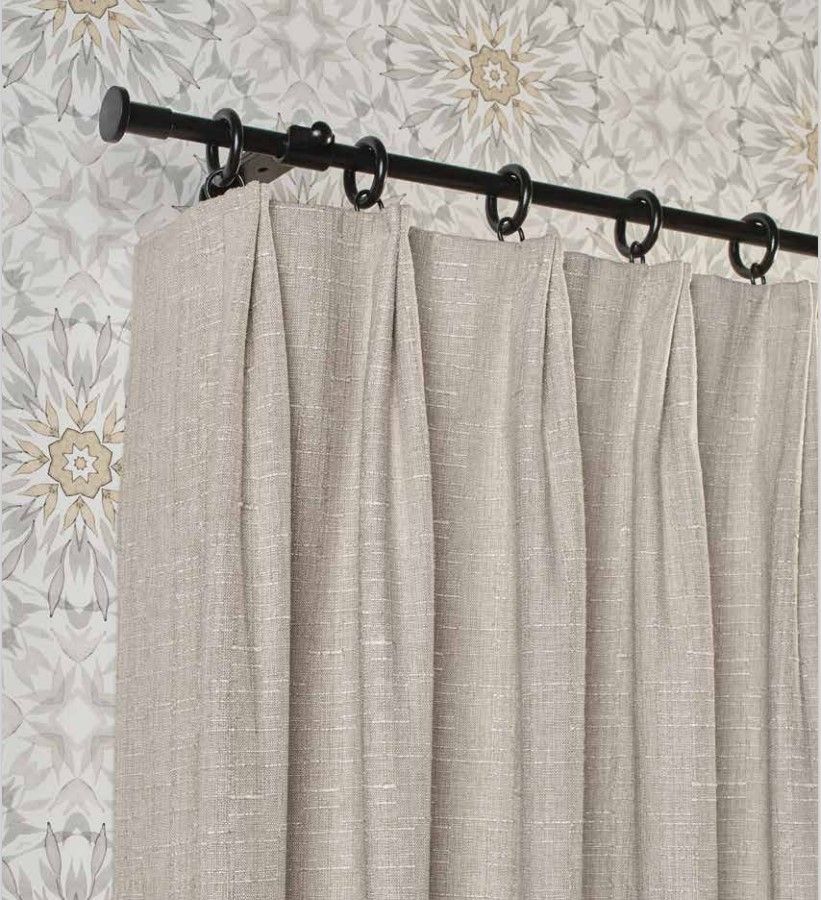 A pair of curtains are hanging on a black curtain rod.
