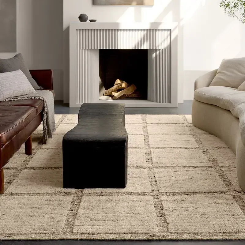 A living room with a fireplace and a rug