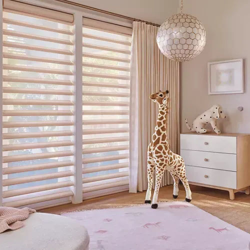 A room with a giraffe standing in front of a window.