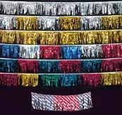 A bunch of colorful ribbons are lined up on a table.