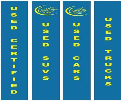 Four blue banners that say used cars suvs and trucks