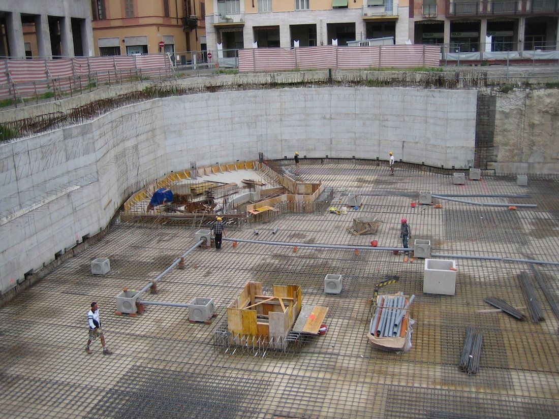 Laying reinforcement foundation slab with positioned water collection wells