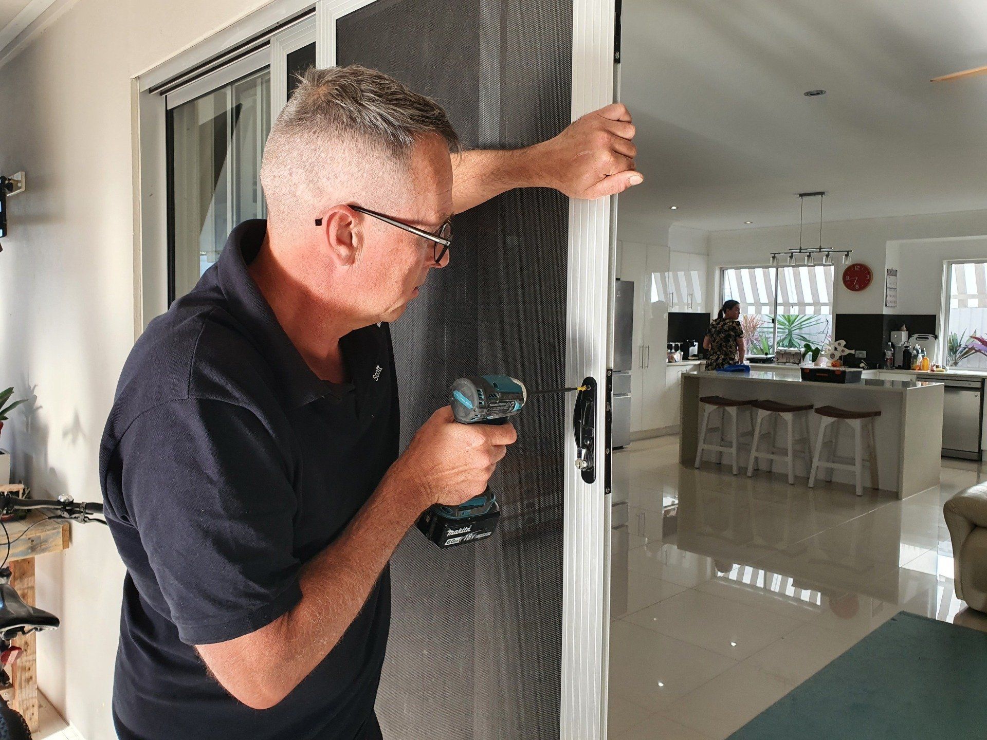 Worker Fixing The Sliding Door With Tools — B&A Doors In Mermaid Waters Queensland