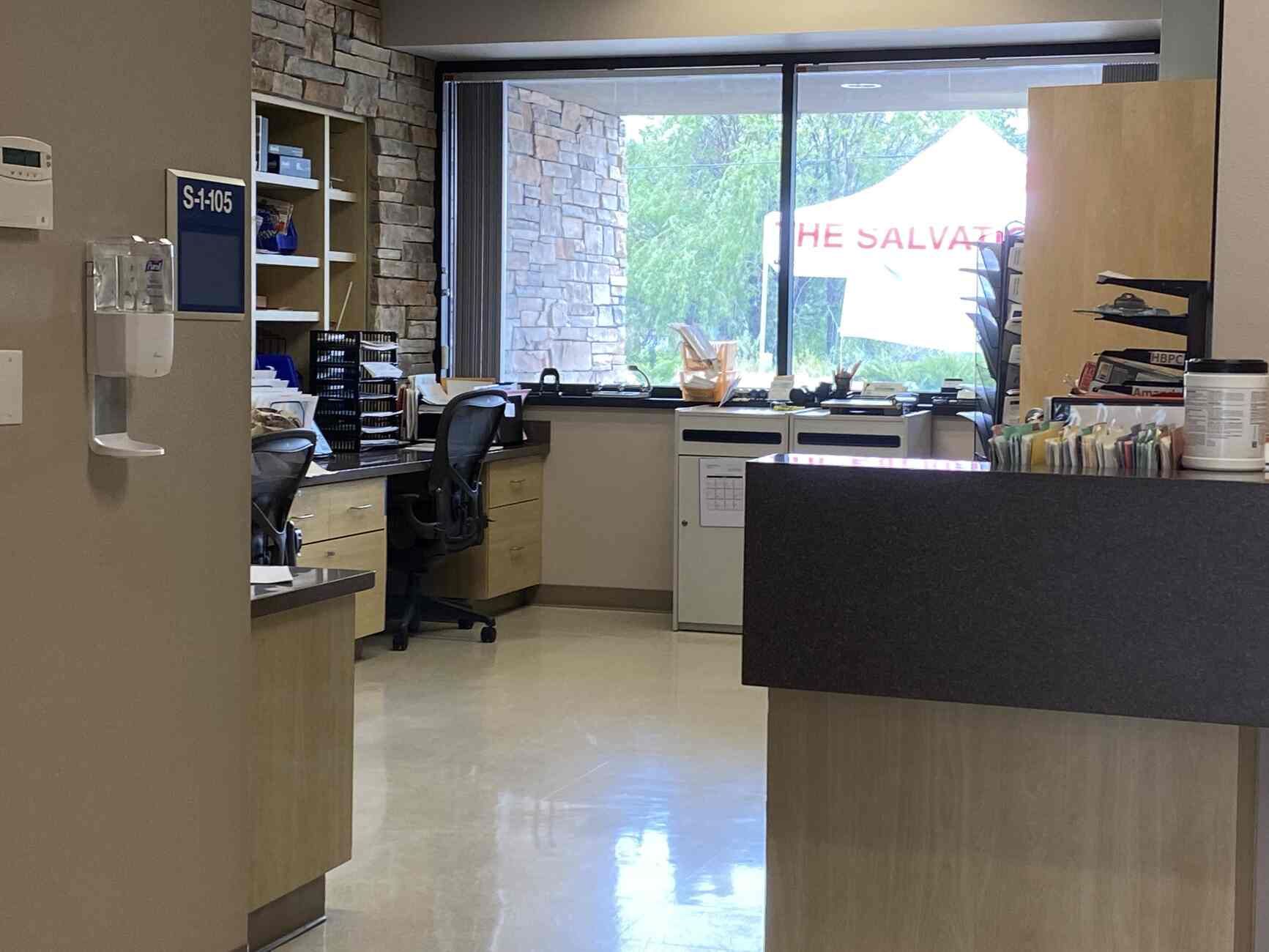 A hospital reception area with a sign that says the salvation army
